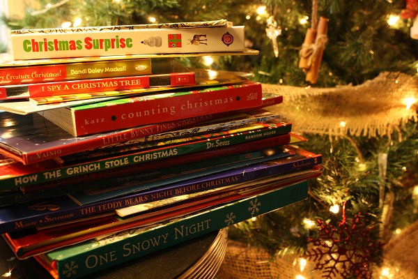 photo of a stack of books in front of a Christmas tree